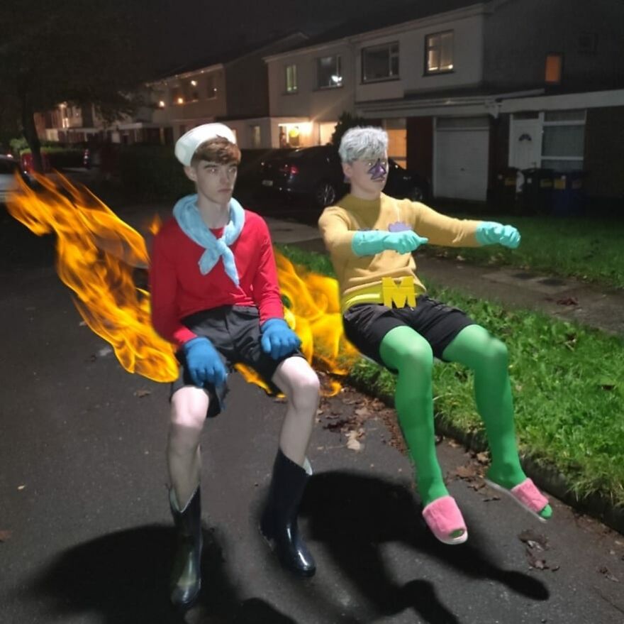 Two young men dressed as Mermaid Man and Barnacle Boy sitting on an invisible boatmobile for Halloween costume ideas.