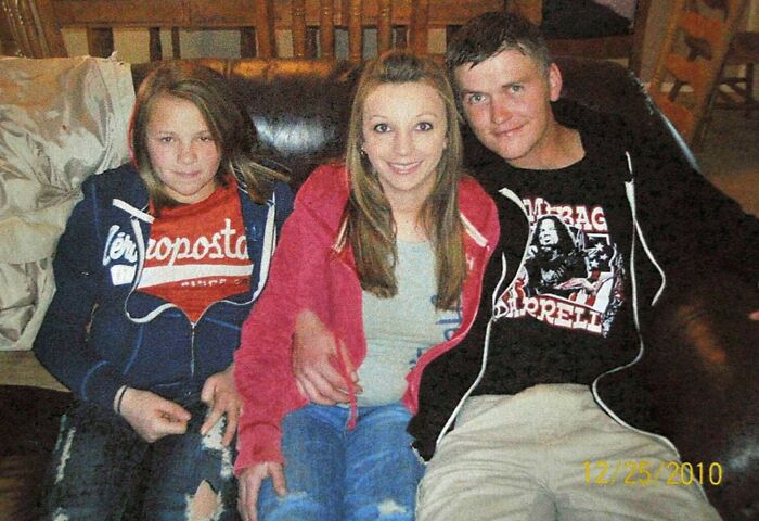 Three friends captured in photos for the last time sitting together on a leather sofa.