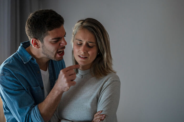 An angry man yelling at a crying woman, representing reasons marriages collapsed