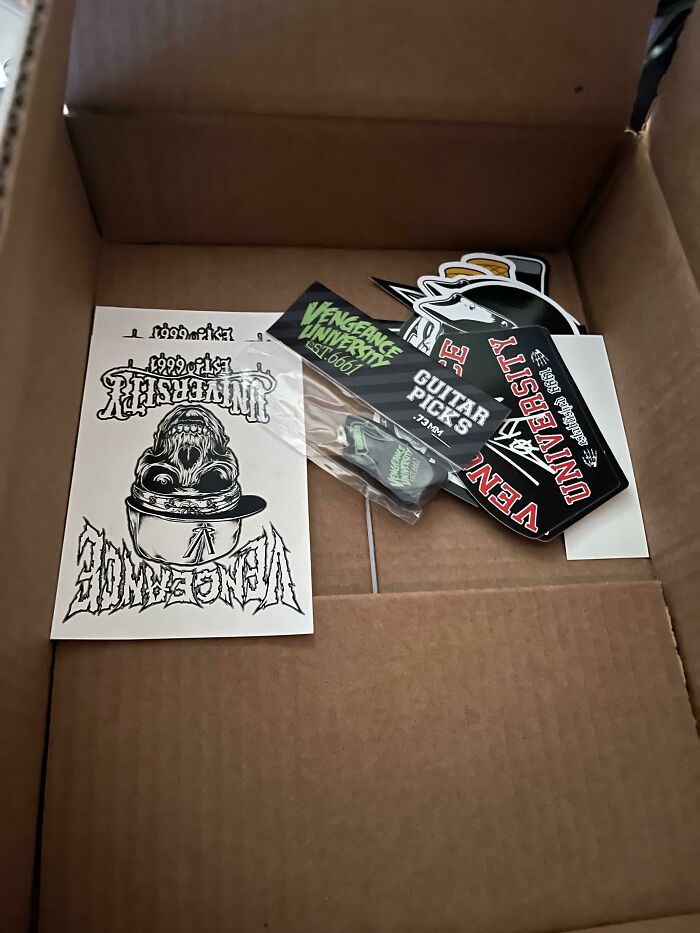 Cardboard shipping box with small stickers illustrating excessive packaging fails