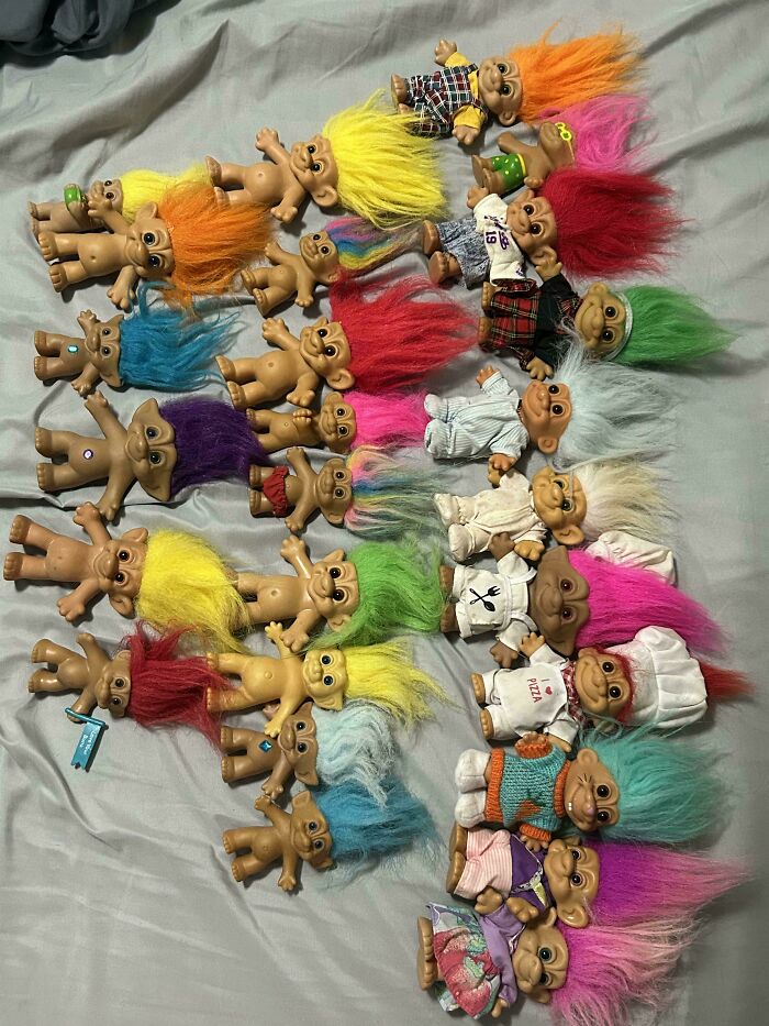 A large collection of colorful vintage Troll dolls, classic thrift store finds.