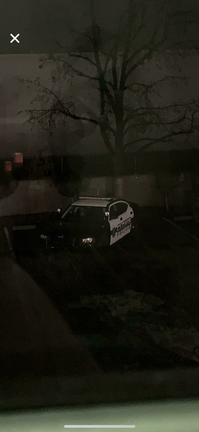 Dark street view of a police car, captured in photos for the last time.