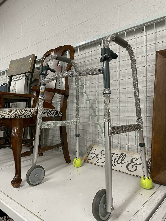 A bedazzled walker with glitter decoration, showcasing unusual thrift store finds on a shelf