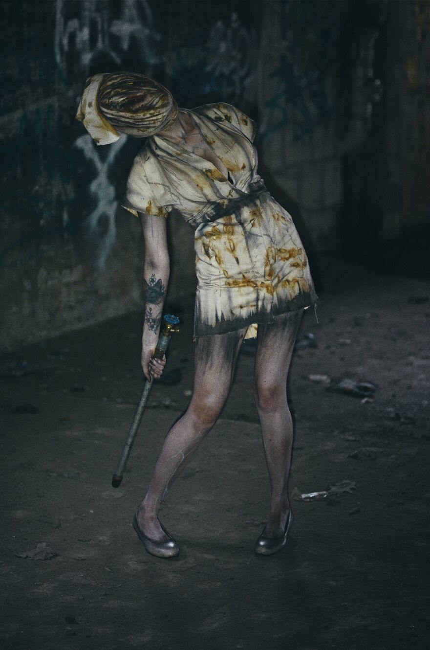 Creepy nurse in a stained outfit holding a pipe, perfect for creative Halloween costume ideas.