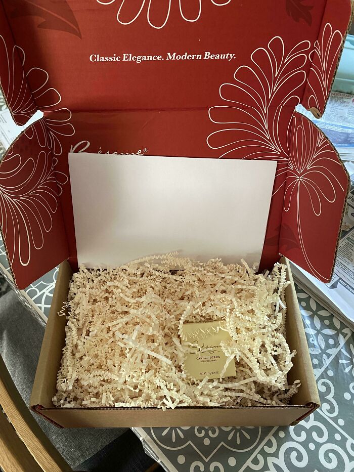 An oversized delivery box filled with paper packing as a bad packaging fail for a tiny item.